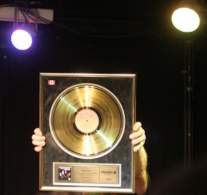 Steve Mahon holding up his Gold record